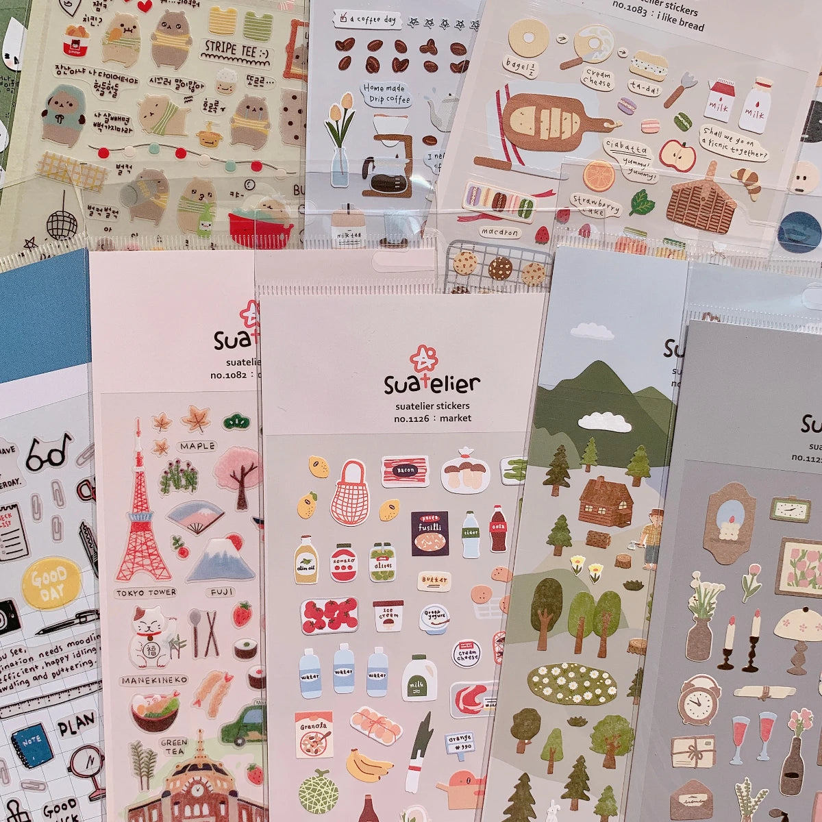 Collection of Sueller sticker sheets with various designs.
